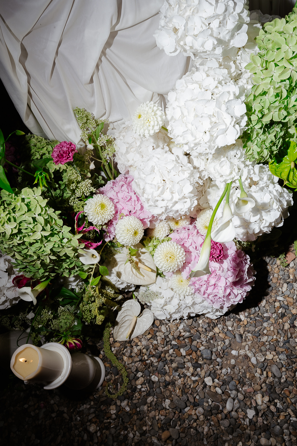 A close-up colour photograph of lush hydrangeas, calla lilies and textured seasonal blooms, highlighting elegant wedding flowers designed for a luxury celebration in France.